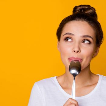 woman licking spoon