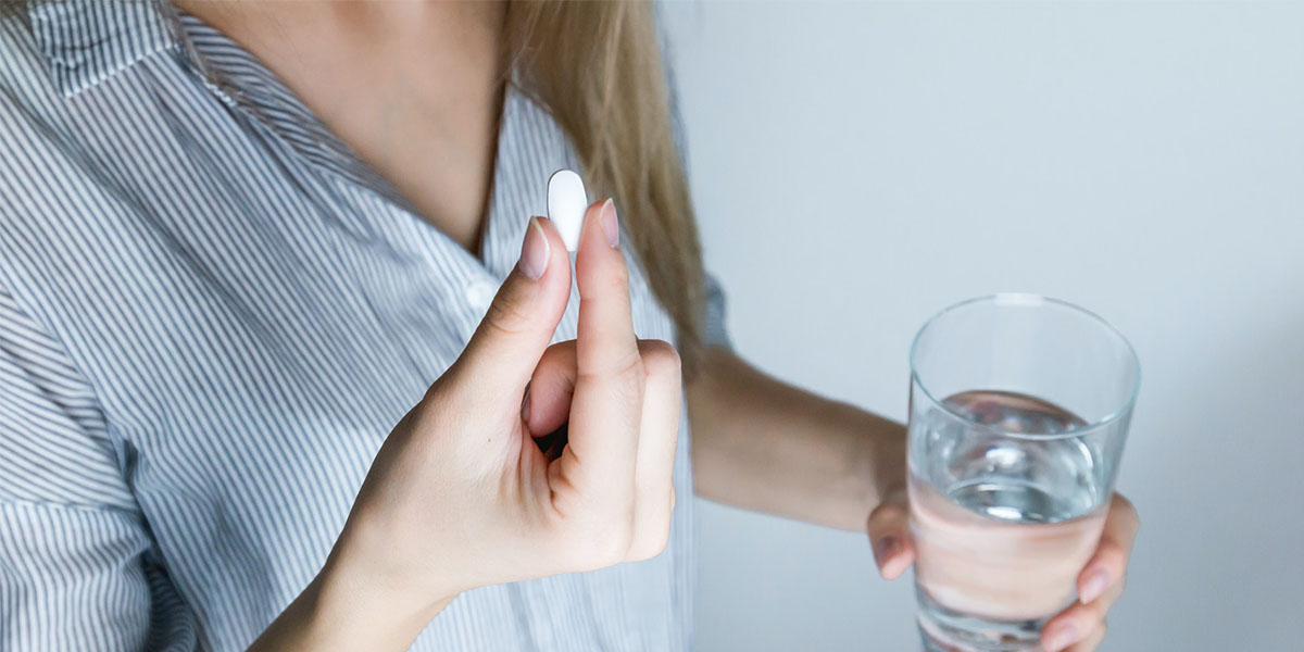 woman taking tablet