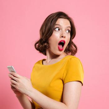 woman with phone looking surprised